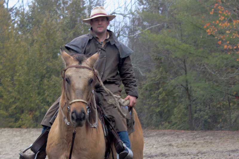 a young rider sitting on a horse with their instructor