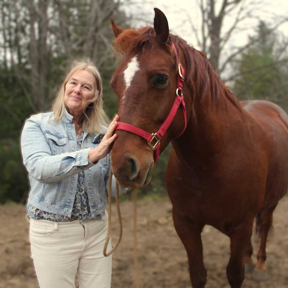 Janet MacFadyen standing with a horse